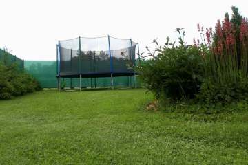 Trampoline with a protective net